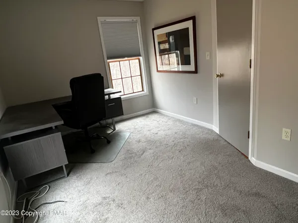 a workspace with furniture and a window