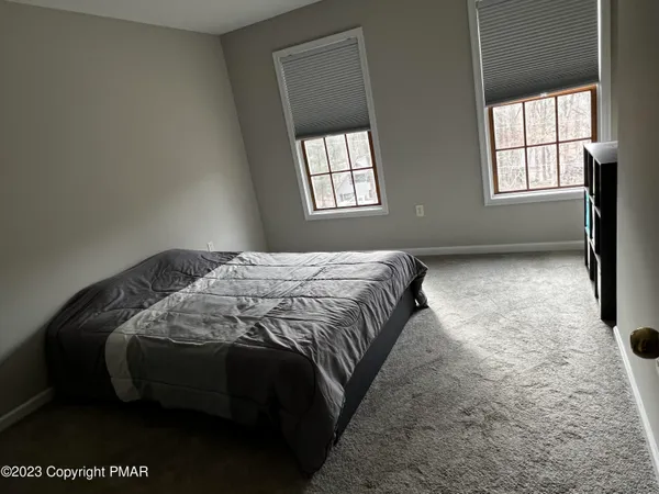 a bed sitting in a bedroom next to a window