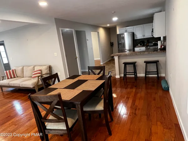 a view of a dining room with furniture and wooden floor