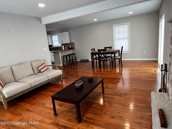 a living room with furniture and wooden floor