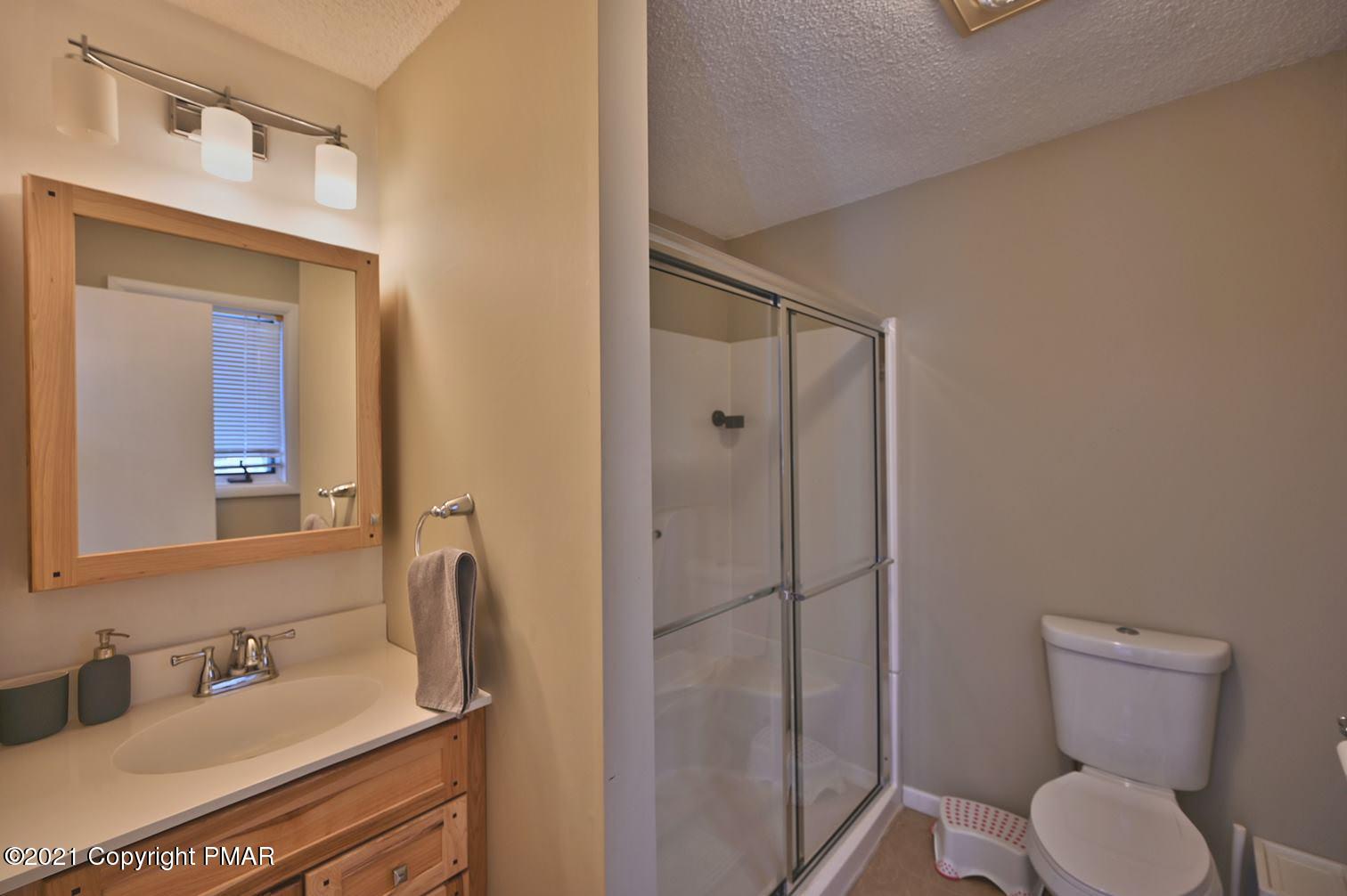 213 Boulder Road Lake Ariel, PA 18436 - Photo 37 of 78 a bathroom with a toilet sink shower and mirror