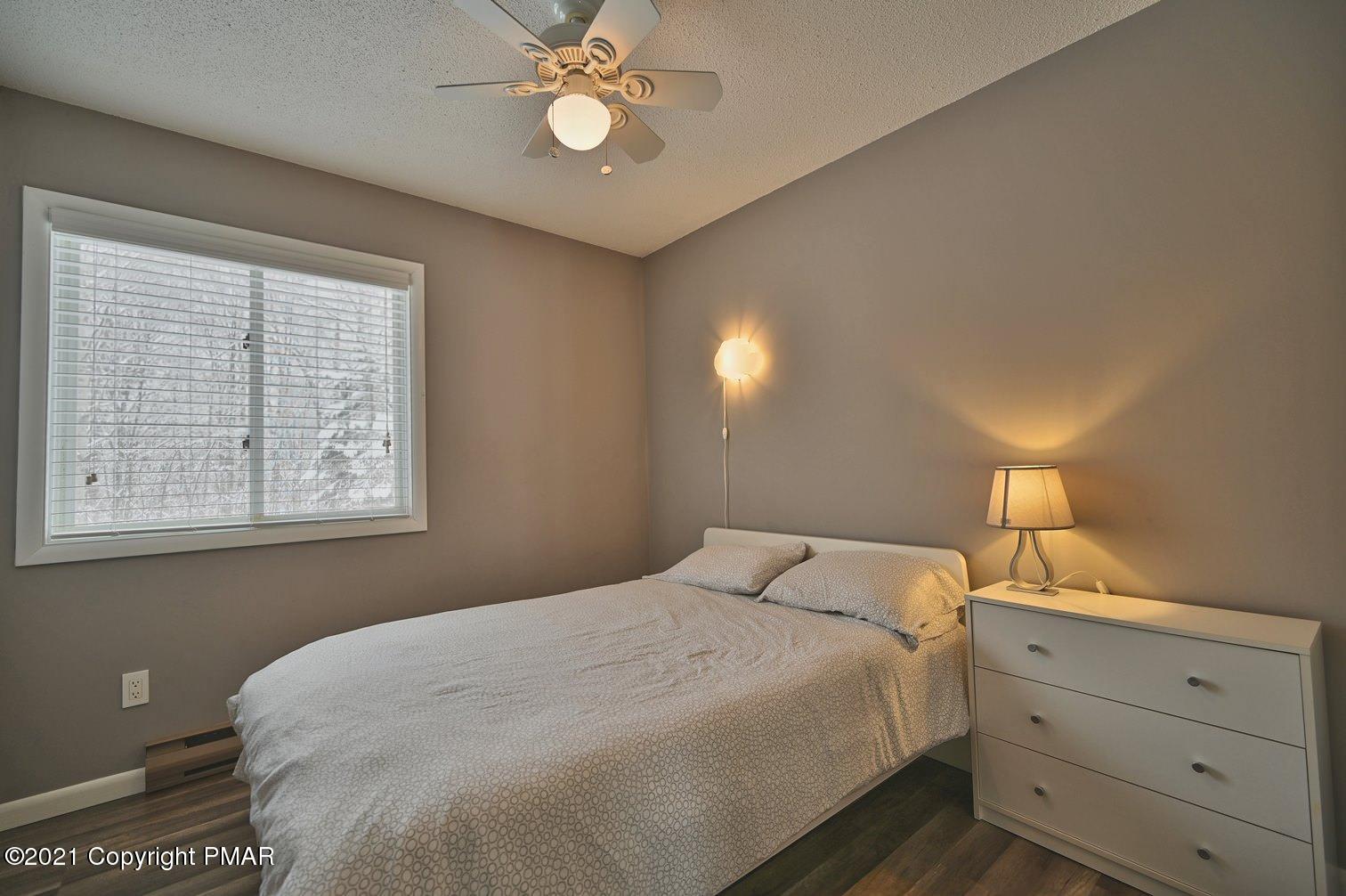 213 Boulder Road Lake Ariel, PA 18436 - Photo 39 of 78 a bedroom with a large bed and a chandelier