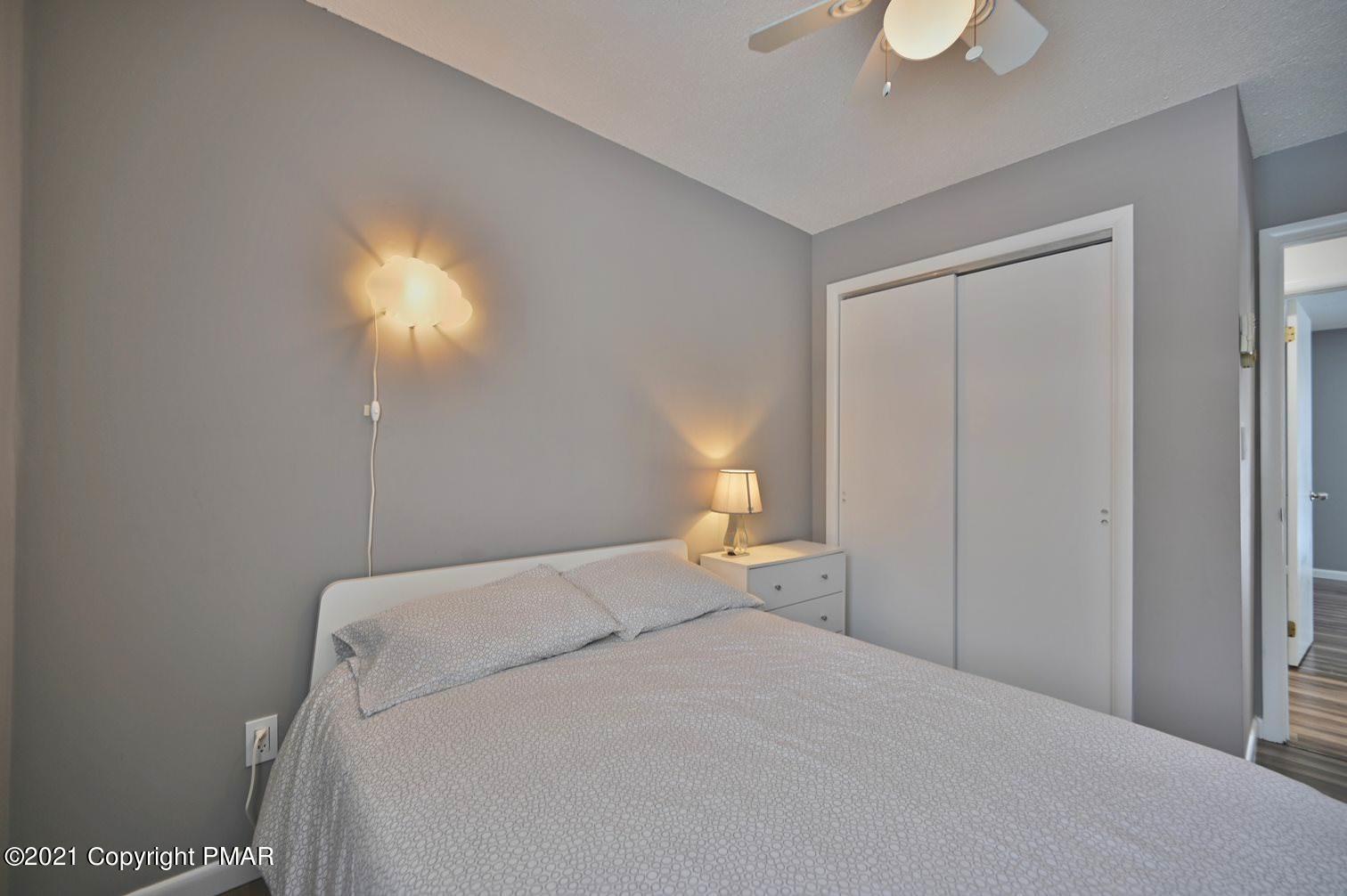 213 Boulder Road Lake Ariel, PA 18436 - Photo 40 of 78 a bedroom with a bed and a chandelier