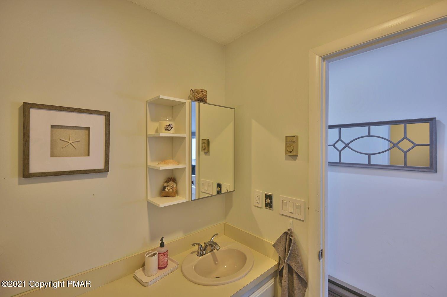 213 Boulder Road Lake Ariel, PA 18436 - Photo 45 of 78 a bathroom with a sink and a mirror