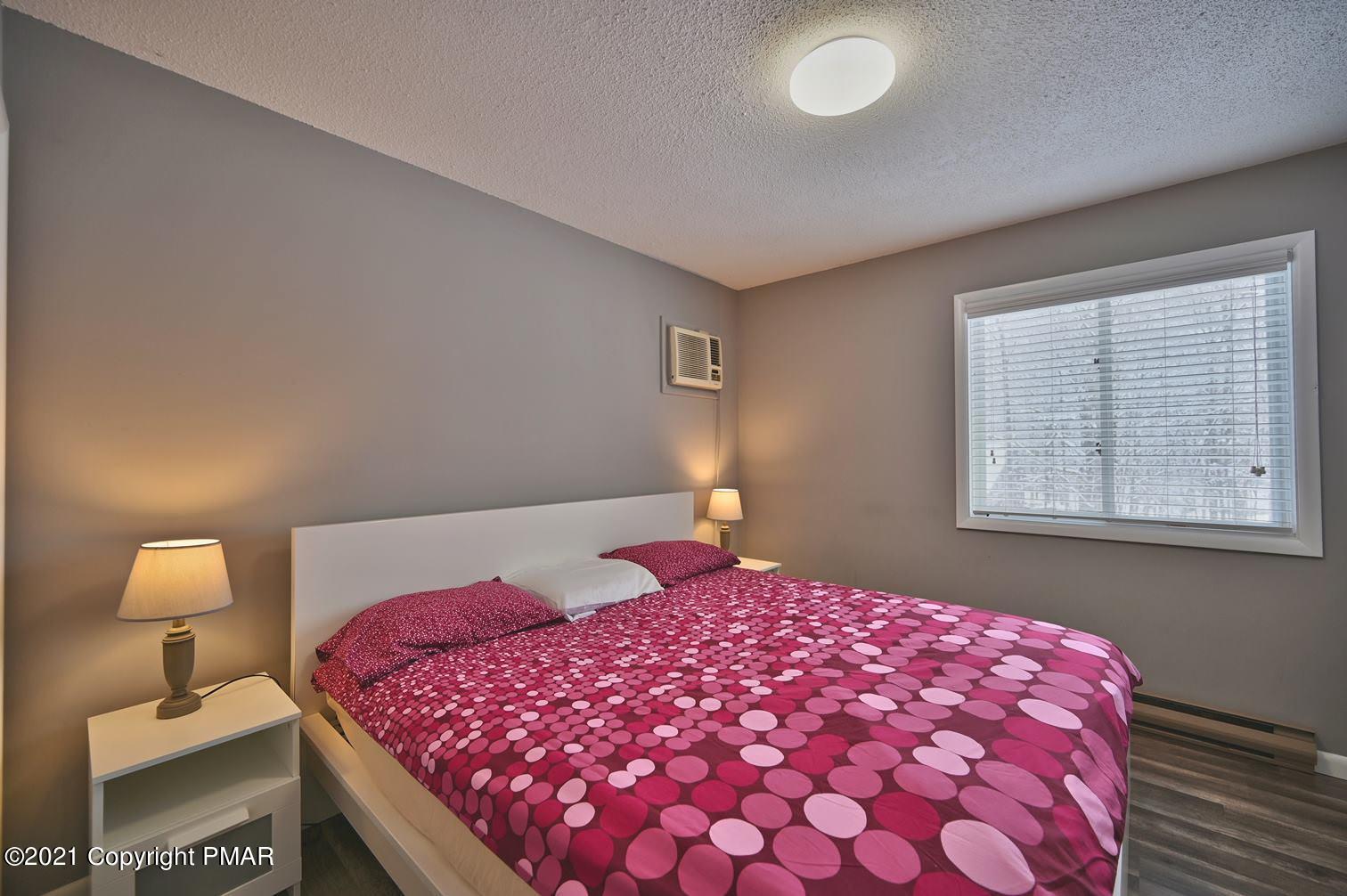 213 Boulder Road Lake Ariel, PA 18436 - Photo 47 of 78 a bedroom with a bed and a lamp