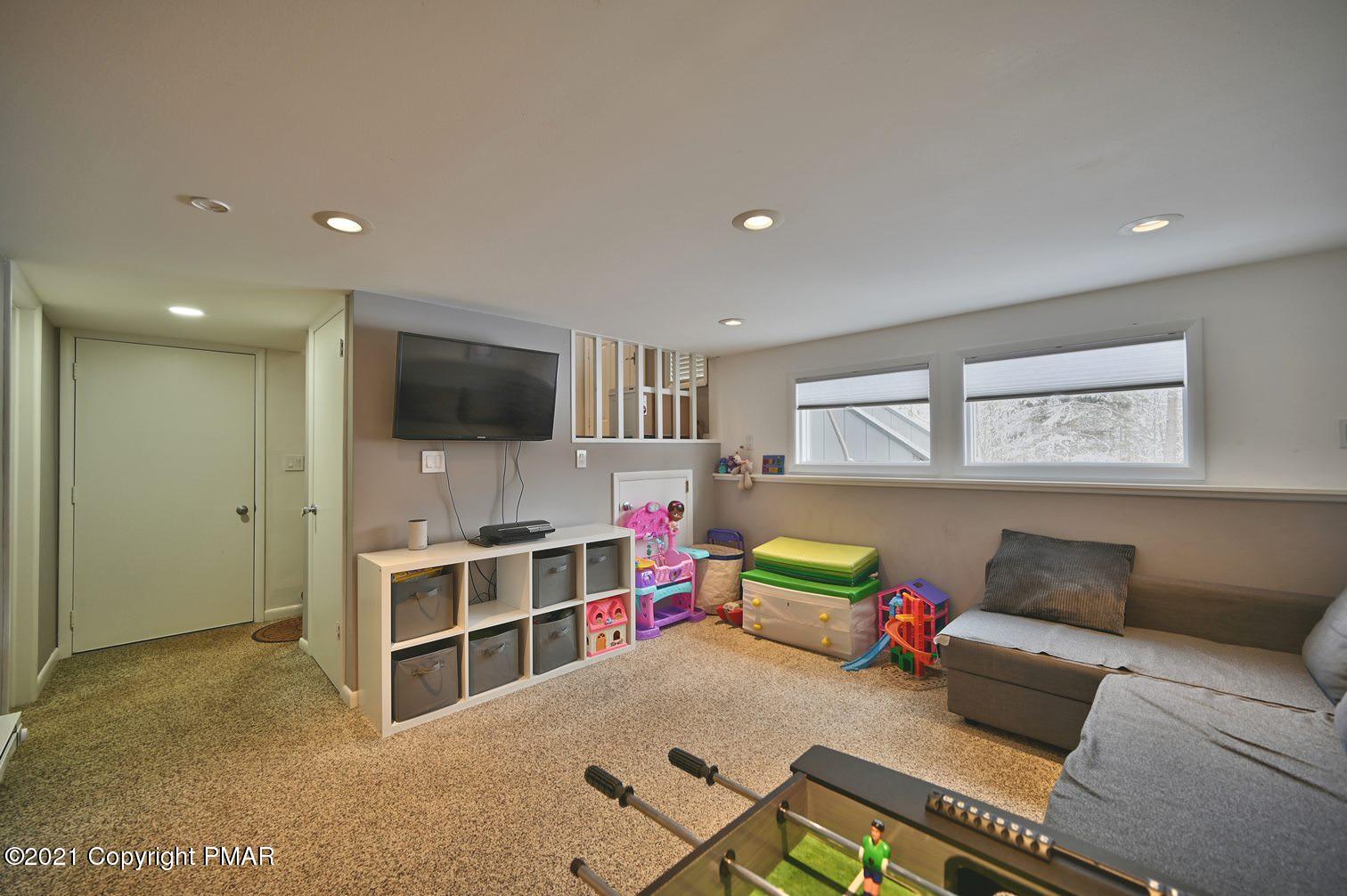 213 Boulder Road Lake Ariel, PA 18436 - Photo 51 of 78 a bedroom with furniture and a flat screen tv