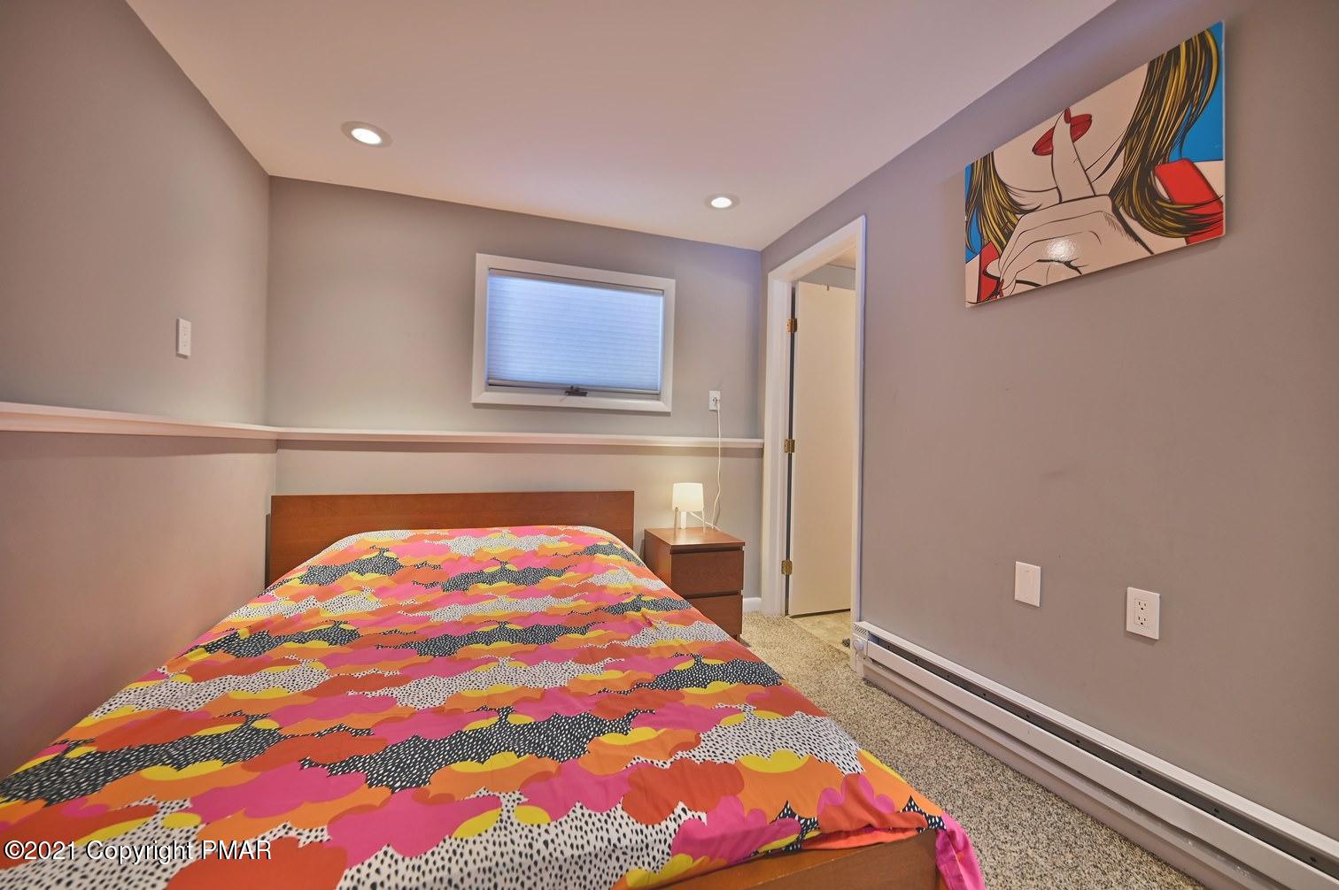 213 Boulder Road Lake Ariel, PA 18436 - Photo 54 of 78 a bedroom with a bed and a painting on the wall