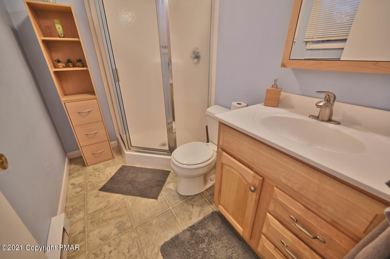 213 Boulder Road Lake Ariel, PA 18436 - Photo 56 of 78 a bathroom with a sink a toilet a mirror and shower
