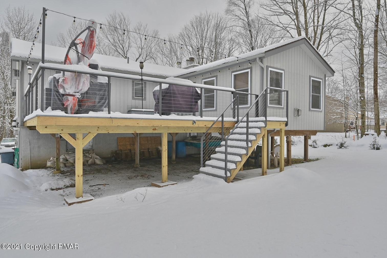 213 Boulder Road Lake Ariel, PA 18436 - Photo 8 of 78 a view of a white house with a large space and a wooden deck
