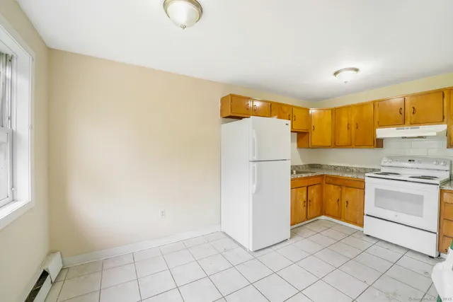 a kitchen with a refrigerator sink stove and cabinets