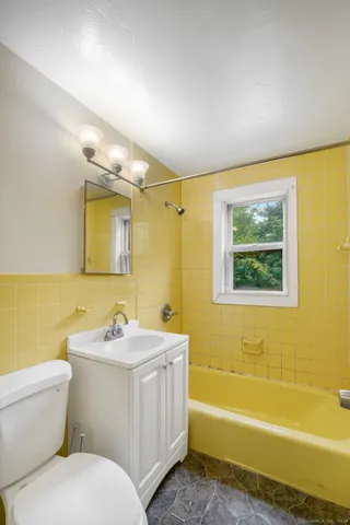 a bathroom with a sink a toilet and bathtub