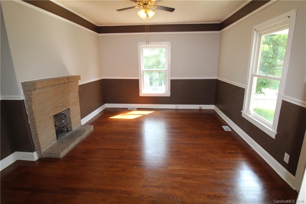 303 McConnell Street, Unit 71 Clover, SC 29710 - Photo 2 of 14 a view of an empty room with window and wooden floor