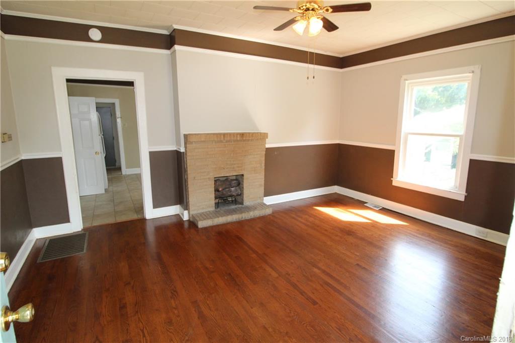 303 McConnell Street, Unit 71 Clover, SC 29710 - Photo 3 of 14 a view of an empty room with a window and wooden floor
