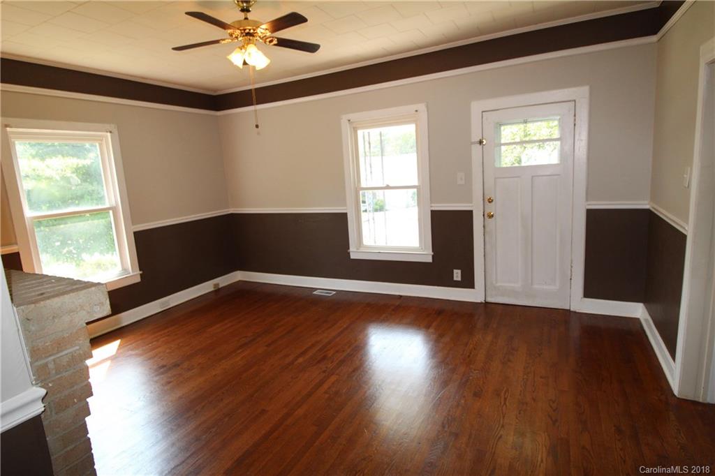 303 McConnell Street, Unit 71 Clover, SC 29710 - Photo 4 of 14 a view of an empty room with wooden floor and a window