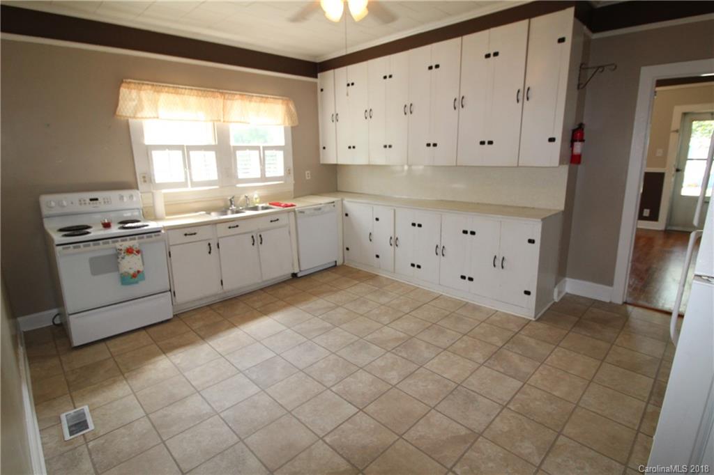 303 McConnell Street, Unit 71 Clover, SC 29710 - Photo 5 of 14 a kitchen with granite countertop white cabinets and white appliances