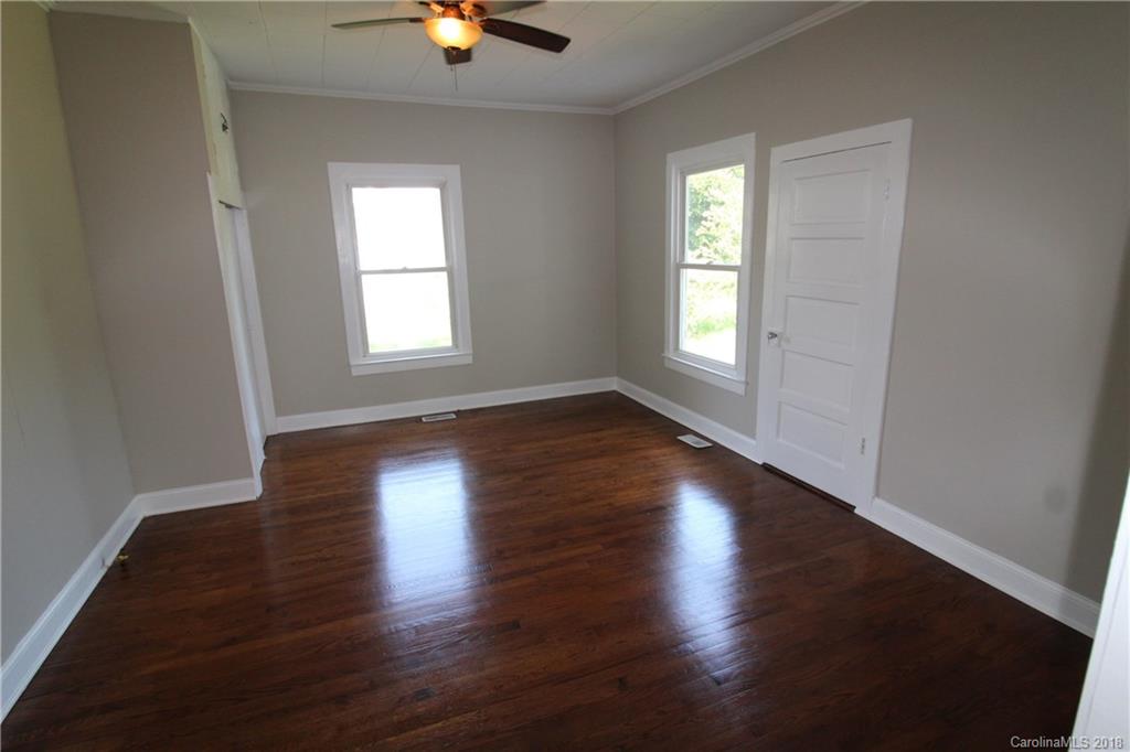 303 McConnell Street, Unit 71 Clover, SC 29710 - Photo 10 of 14 an empty room with wooden floor and windows