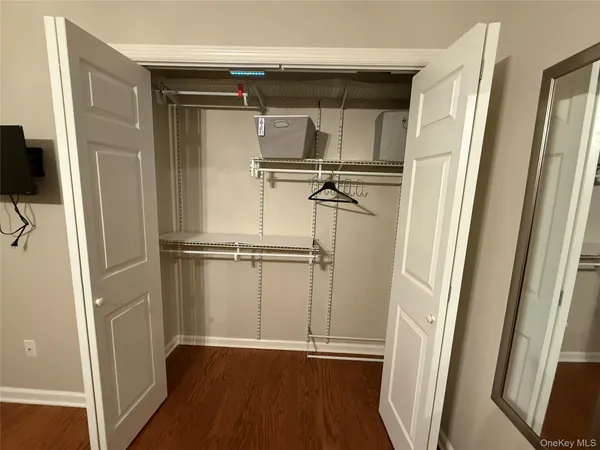 a view of walk in closet with empty racks