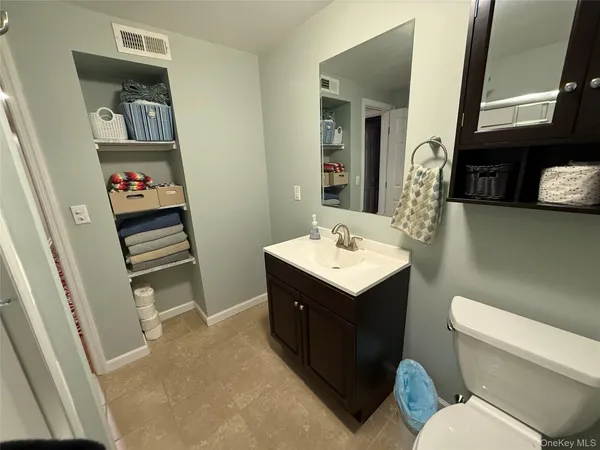 a bathroom with a sink toilet and mirror