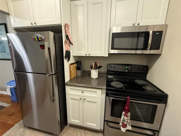 a kitchen with a refrigerator stove and microwave