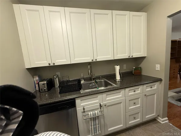 a kitchen with stainless steel appliances granite countertop a sink a stove and dishwasher with cabinets