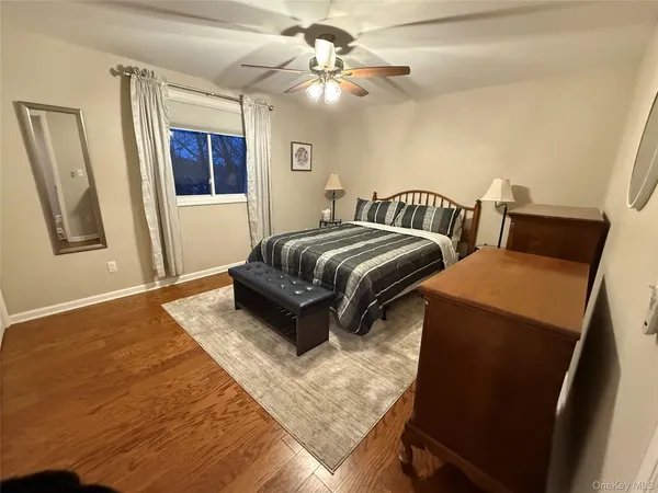 a spacious bedroom with a bed and window