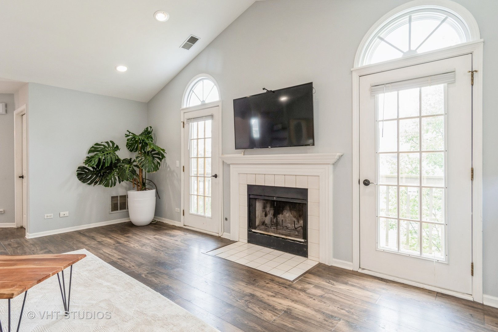 1245 Rhodes Lane, Unit 1245 Naperville, IL 60540 - Photo 11 of 17 a living room with furniture a fireplace and a flat screen tv