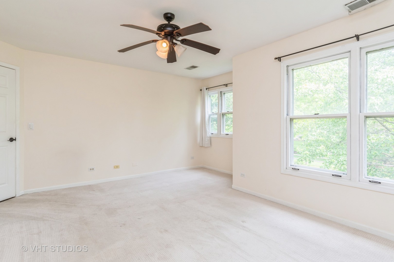 1245 Rhodes Lane, Unit 1245 Naperville, IL 60540 - Photo 13 of 17 an empty room with a window and a fan
