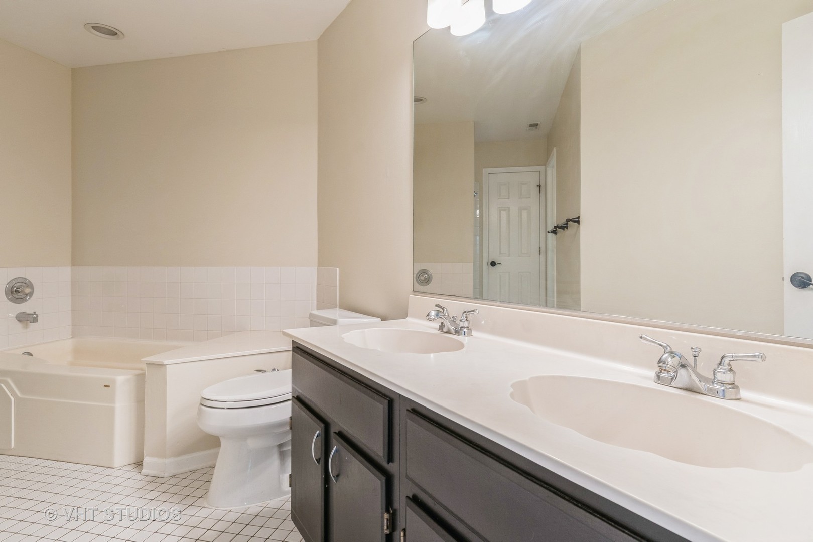 1245 Rhodes Lane, Unit 1245 Naperville, IL 60540 - Photo 15 of 17 a bathroom with a granite countertop sink a toilet and a large mirror