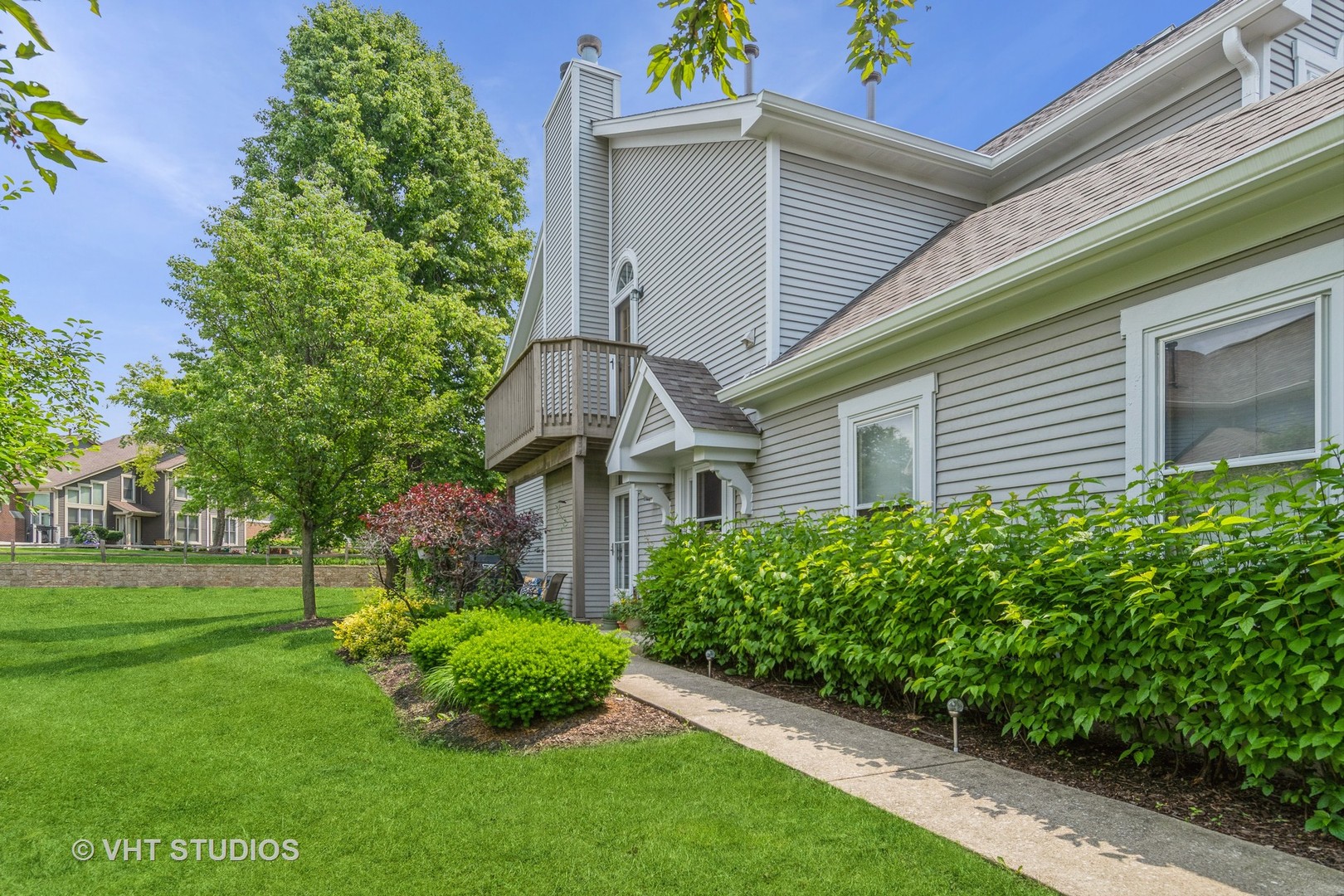 1245 Rhodes Lane, Unit 1245 Naperville, IL 60540 - Photo 17 of 17 a front view of a house with a garden