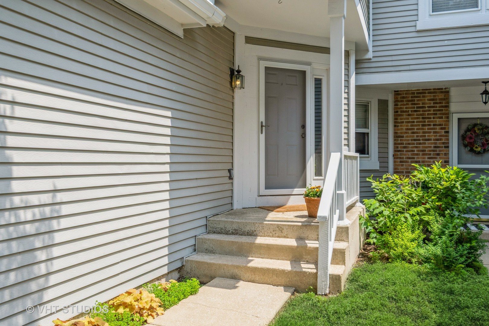 1245 Rhodes Lane, Unit 1245 Naperville, IL 60540 - Photo 2 of 17 a front view of a house with a yard