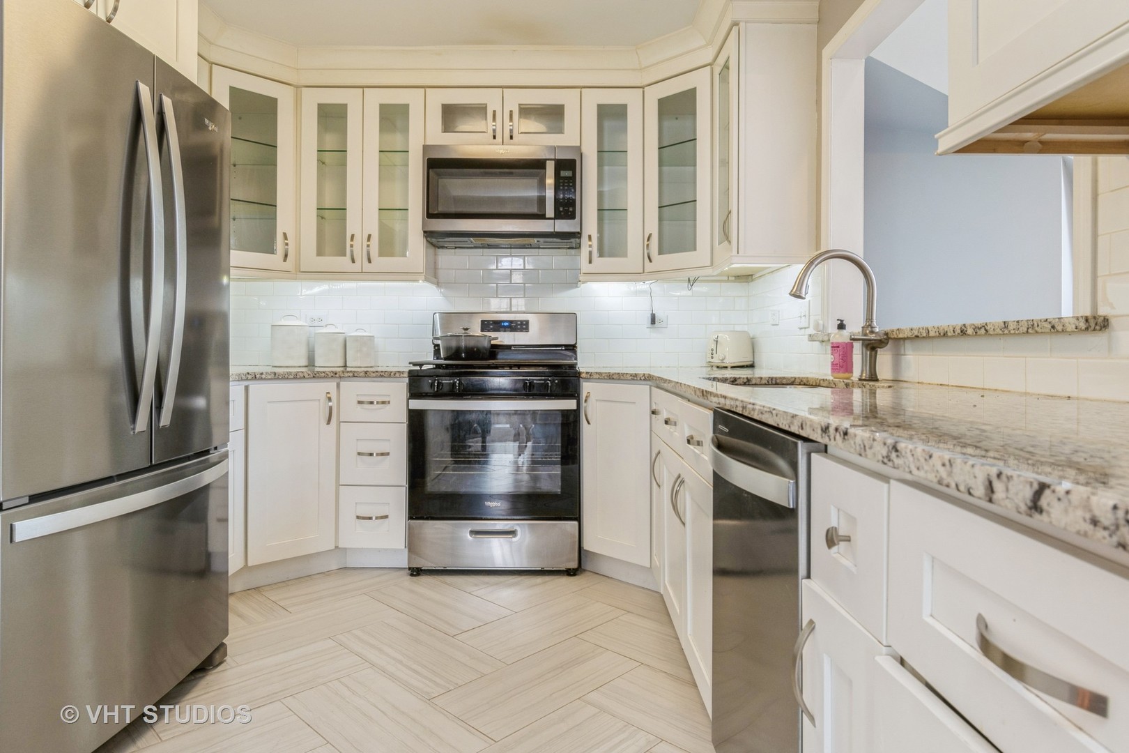 1245 Rhodes Lane, Unit 1245 Naperville, IL 60540 - Photo 4 of 17 a kitchen with stainless steel appliances granite countertop a refrigerator stove and sink