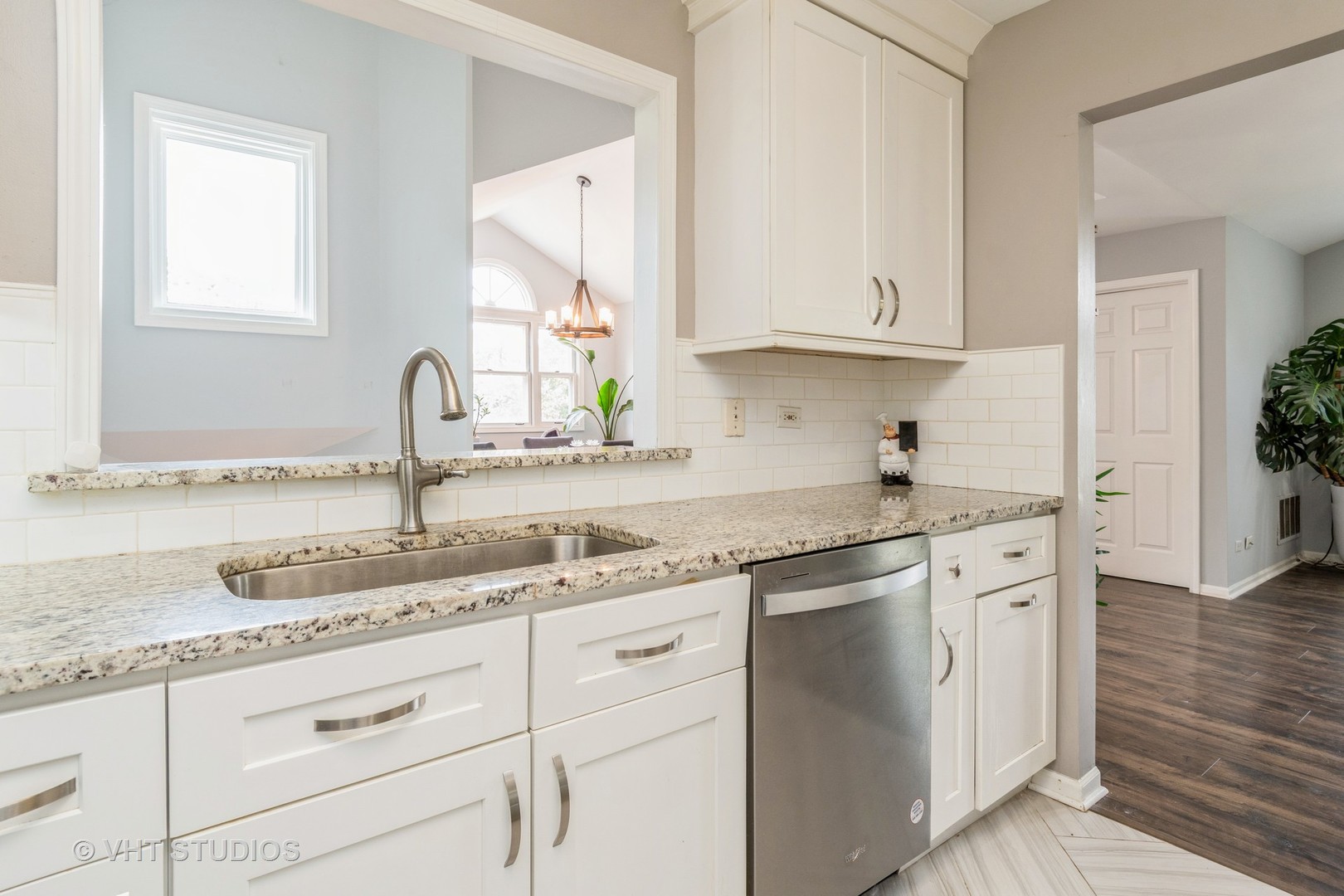 1245 Rhodes Lane, Unit 1245 Naperville, IL 60540 - Photo 5 of 17 a kitchen with granite countertop white cabinets and a sink
