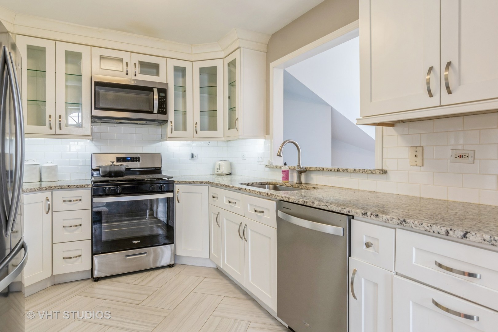 1245 Rhodes Lane, Unit 1245 Naperville, IL 60540 - Photo 6 of 17 a kitchen with granite countertop white cabinets and stainless steel appliances
