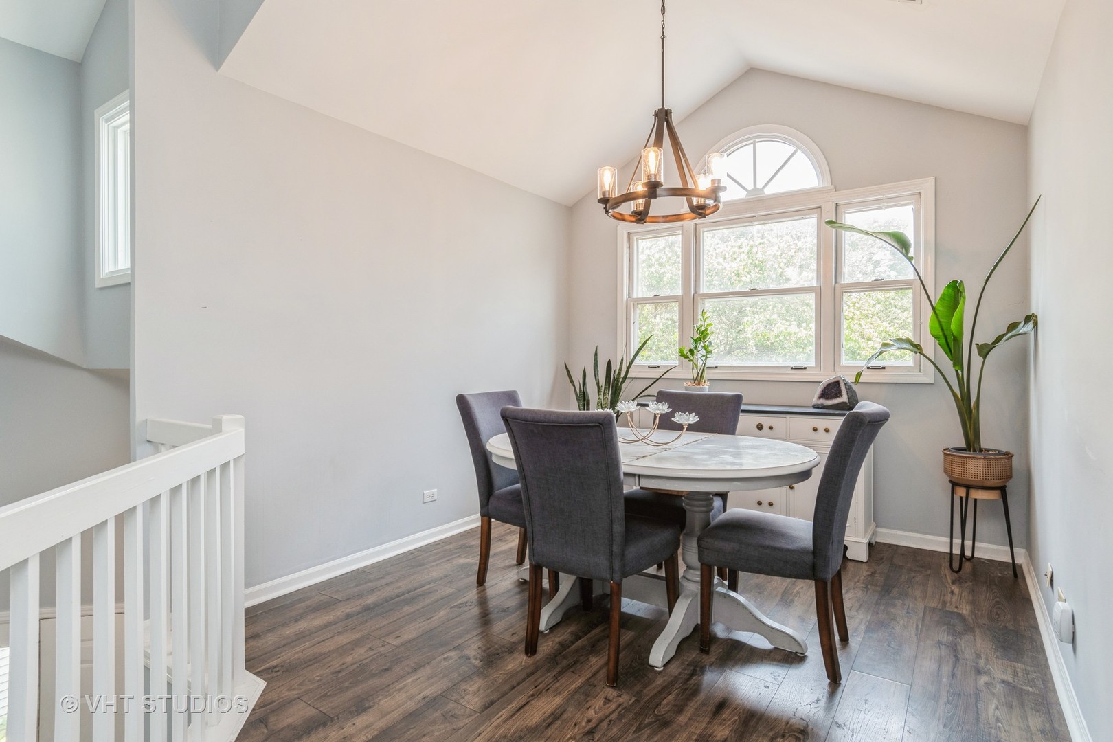 1245 Rhodes Lane, Unit 1245 Naperville, IL 60540 - Photo 7 of 17 a view of a dining room with furniture a chandelier and wooden floor