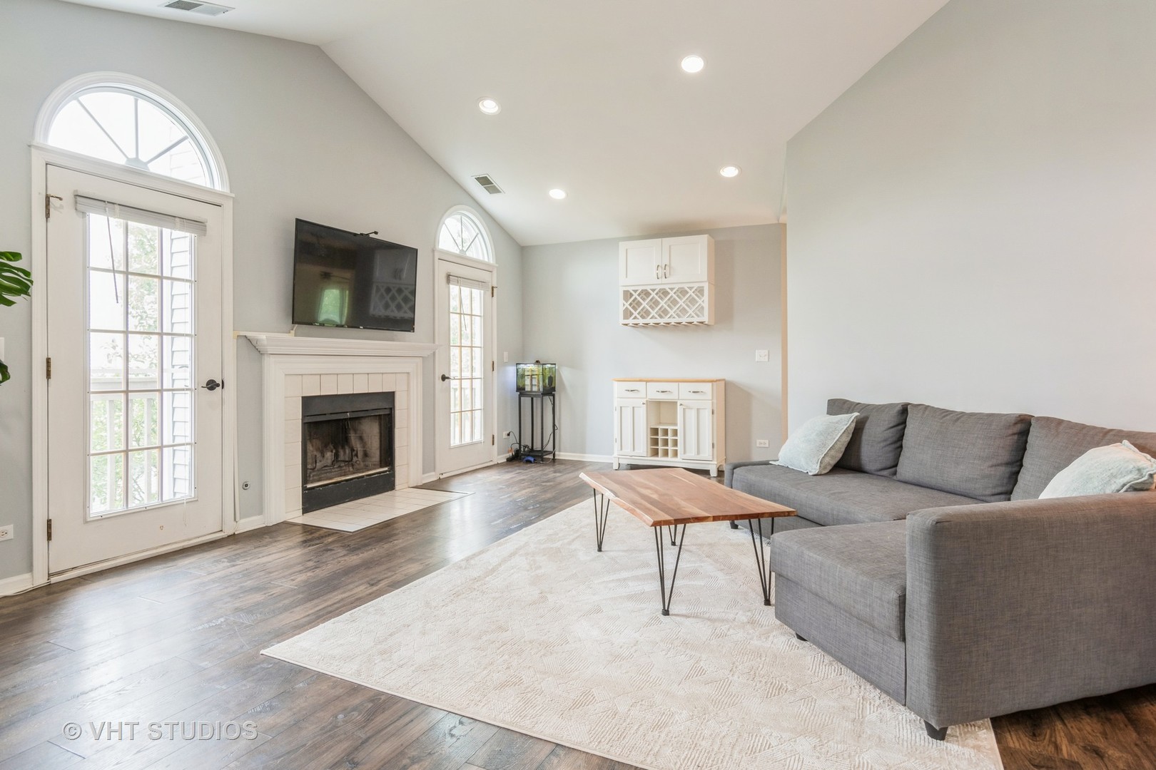 1245 Rhodes Lane, Unit 1245 Naperville, IL 60540 - Photo 9 of 17 a living room with furniture a flat screen tv and a fireplace