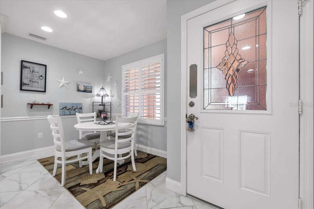 1260 Rio De Janeiro Avenue, Unit 102 Punta Gorda, FL 33983 - Photo 19 of 46 a view of a dining room with furniture window and outside view