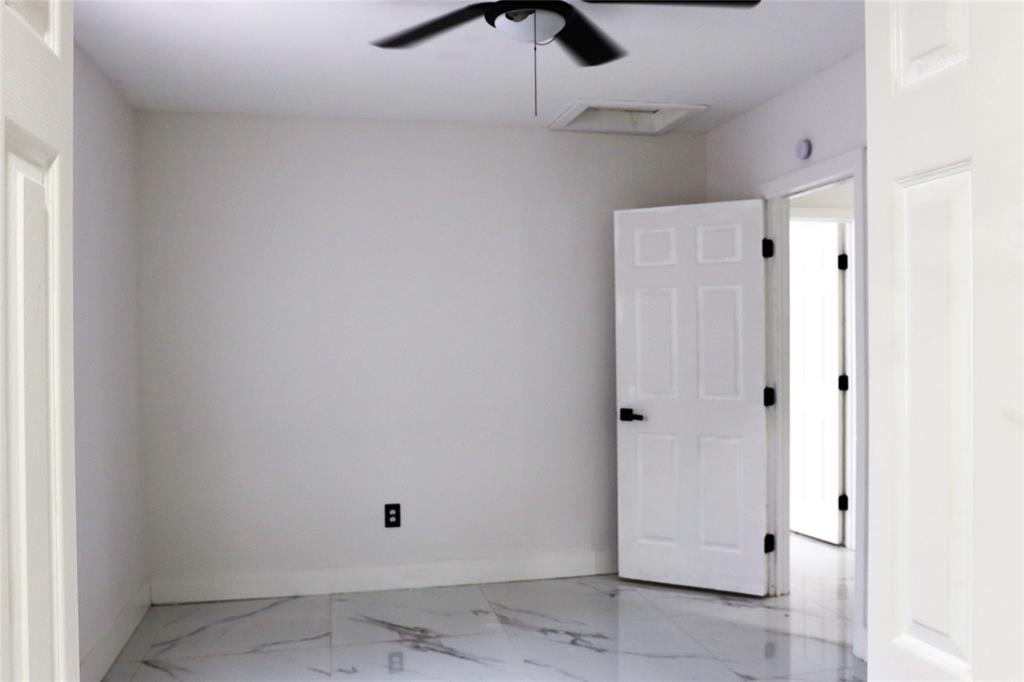3075 Northwest 68th Street Miami, FL 33147 - Photo 11 of 24 a view of a hallway with a window