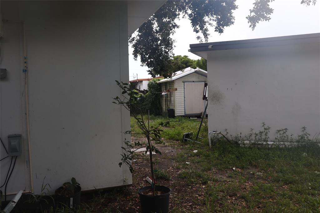 3075 Northwest 68th Street Miami, FL 33147 - Photo 18 of 24 a backyard of a house with lots of green space