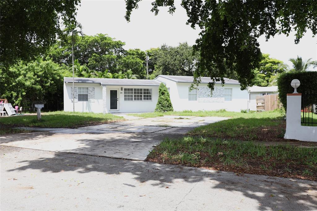 3075 Northwest 68th Street Miami, FL 33147 - Photo 2 of 24 a view of a house with a yard