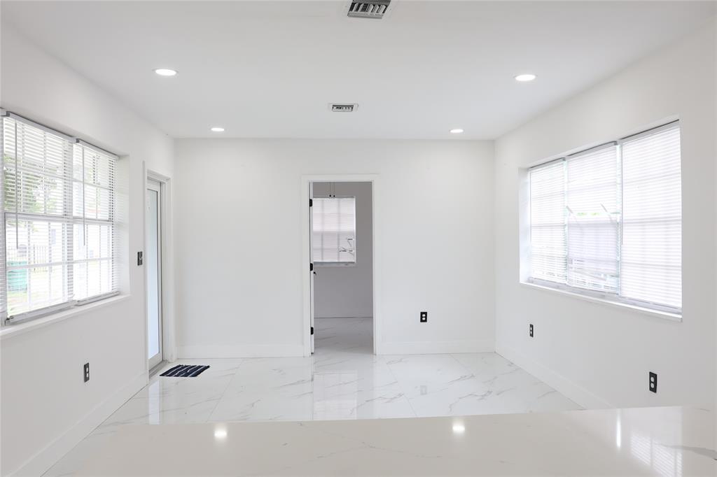 3075 Northwest 68th Street Miami, FL 33147 - Photo 6 of 24 a view of an empty room with a window