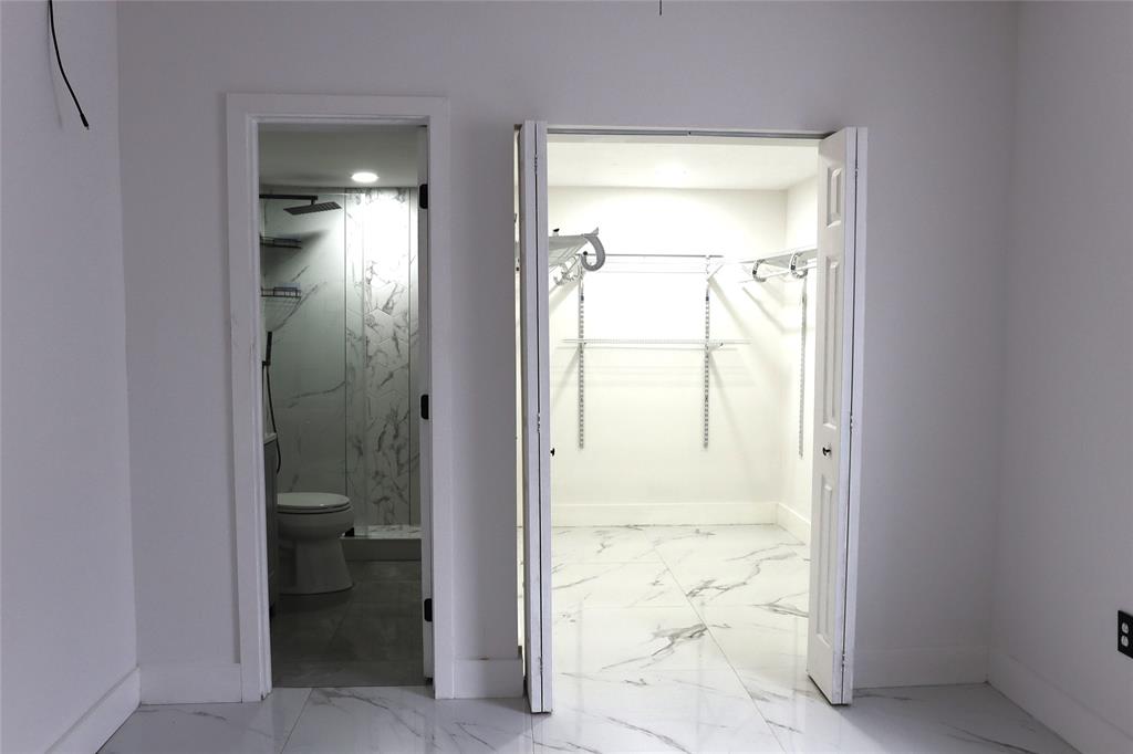 3075 Northwest 68th Street Miami, FL 33147 - Photo 9 of 24 a view of a bathroom with a glass door
