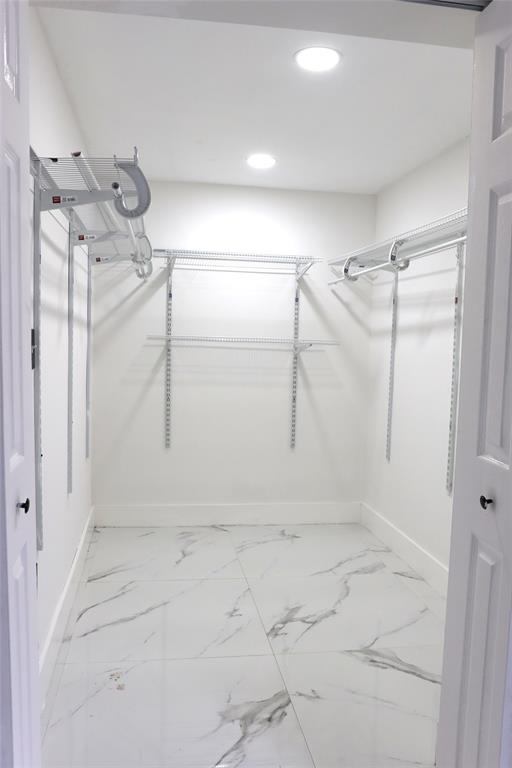 3075 Northwest 68th Street Miami, FL 33147 - Photo 10 of 24 a view of a room with racks on the wall