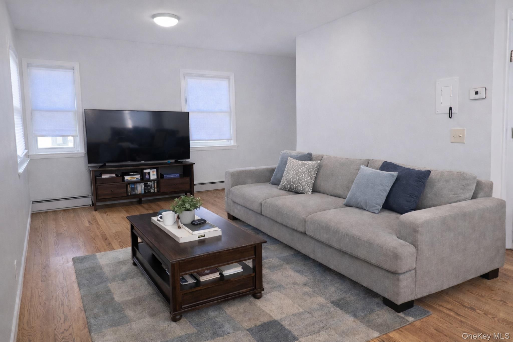 2146 Albany Post Road Montrose, NY 10548 - Photo 4 of 9 a living room with furniture and a flat screen tv
