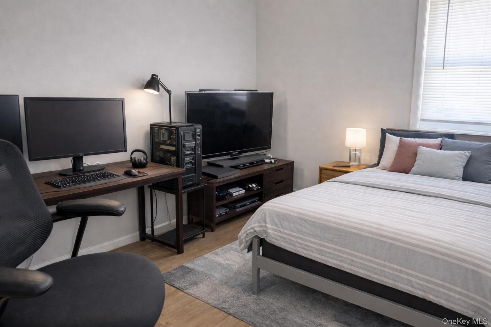 2146 Albany Post Road Montrose, NY 10548 - Photo 7 of 9 a bedroom with a bed and a flat screen tv