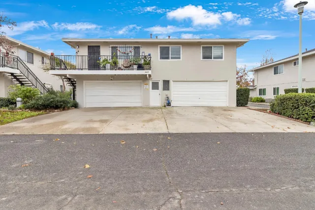 a view of a house with a outdoor space and parking