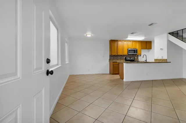 a view of a kitchen with a sink cabinets and a window