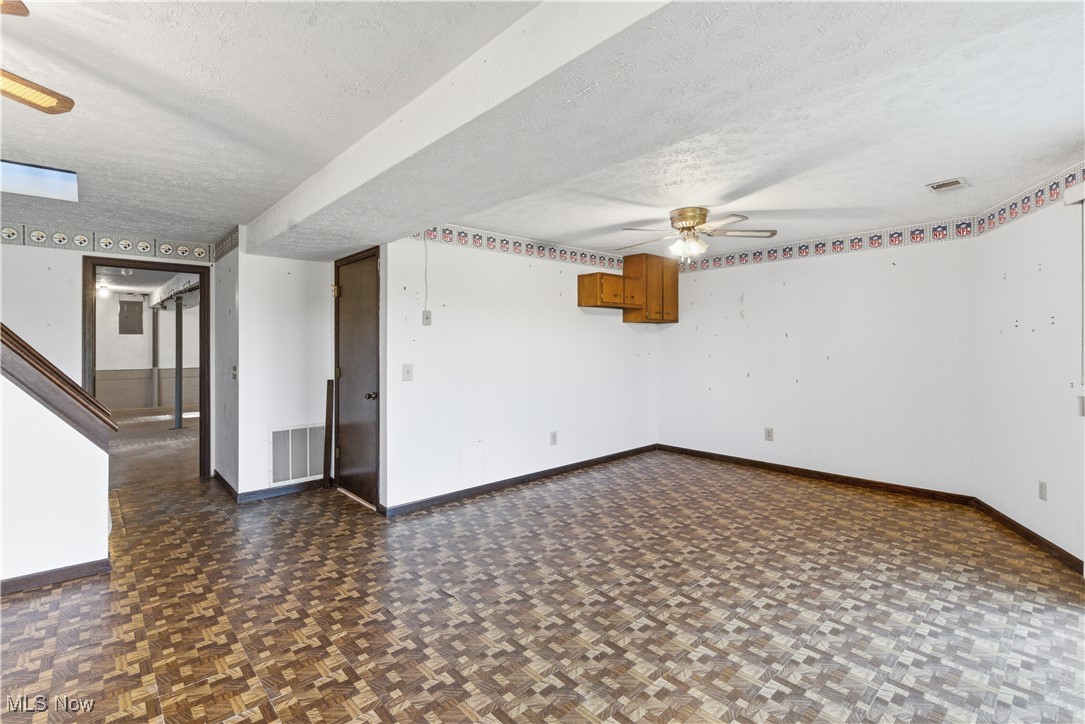 54846 Seneca Lake Road Quaker City, OH 43773 - Photo 5 of 42 Empty room with a textured ceiling and ceiling fan