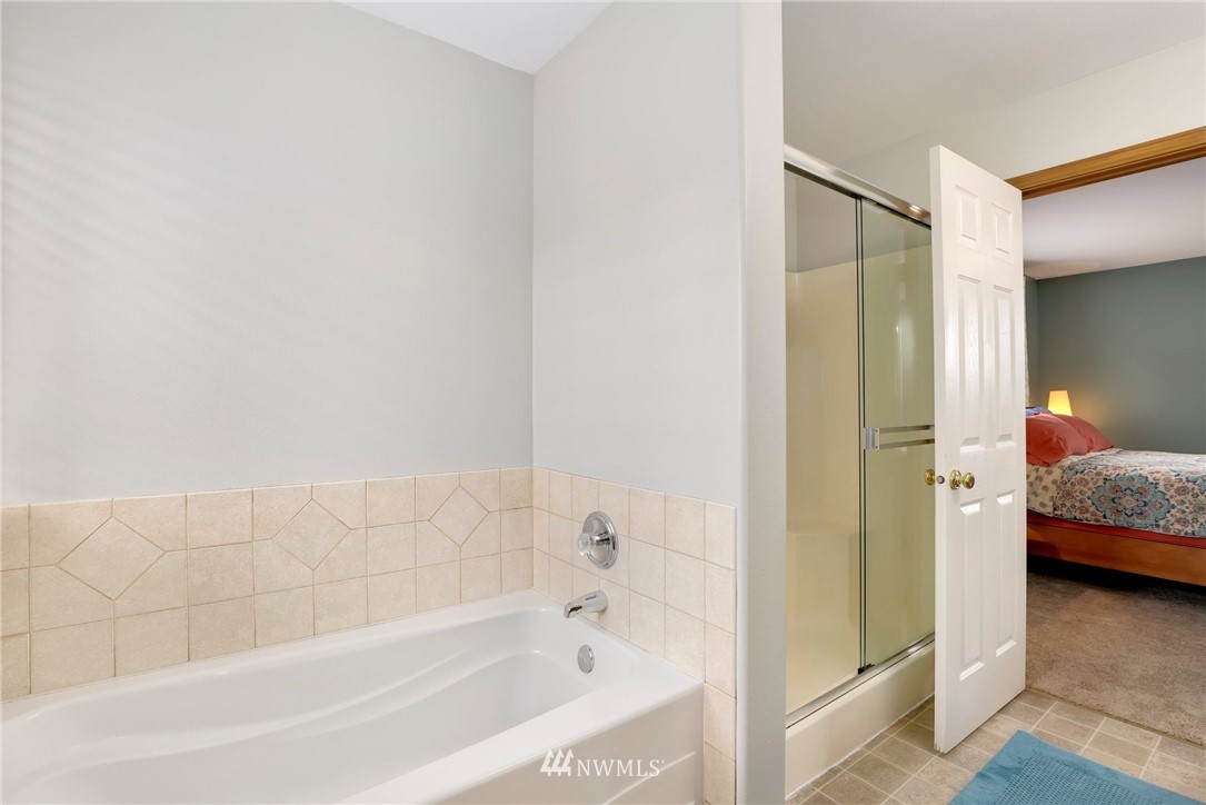 424 170th Place Southeast Bothell, WA 98012 - Photo 22 of 36 a en suite bathroom with a bathtub and a shower