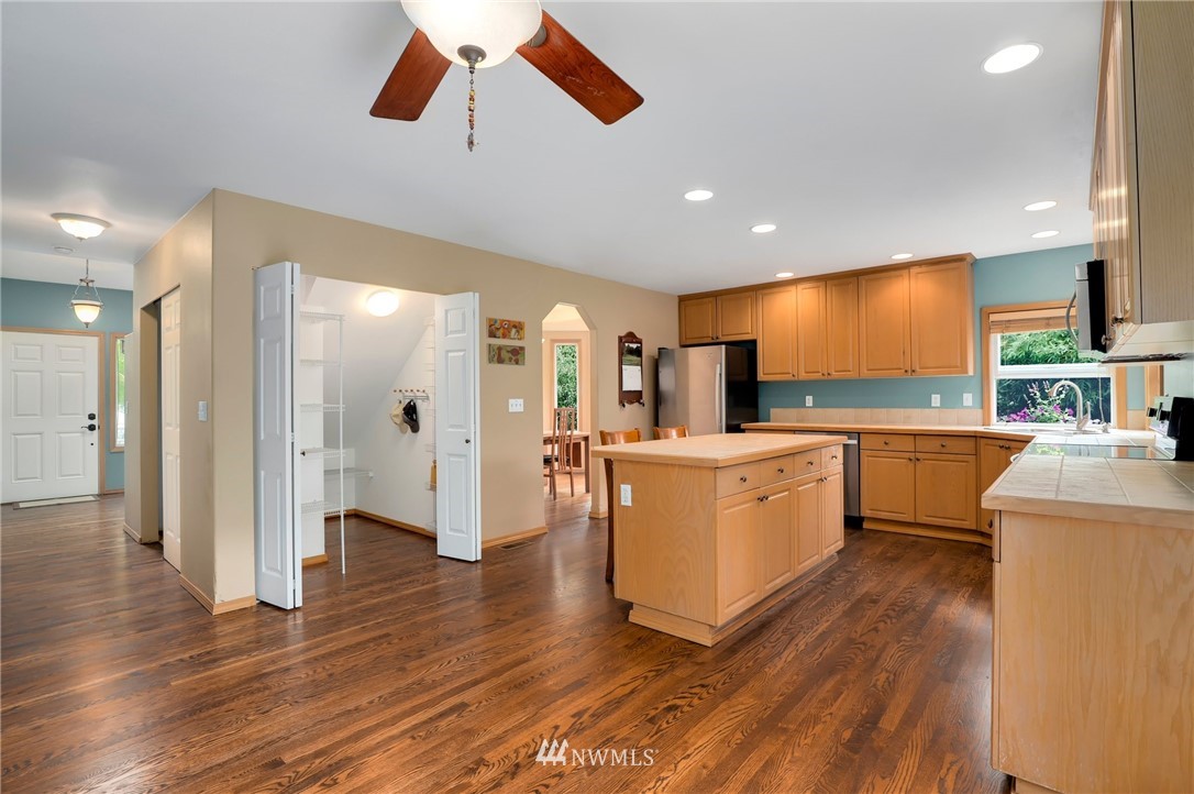 424 170th Place Southeast Bothell, WA 98012 - Photo 8 of 36 a kitchen with white cabinets and stainless steel appliances