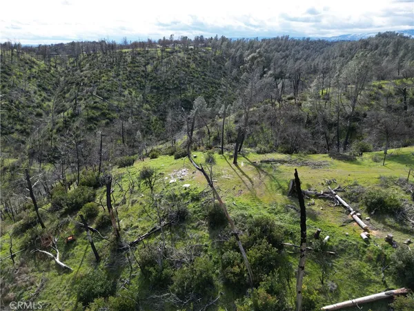 an aerial view of a houses with a yard